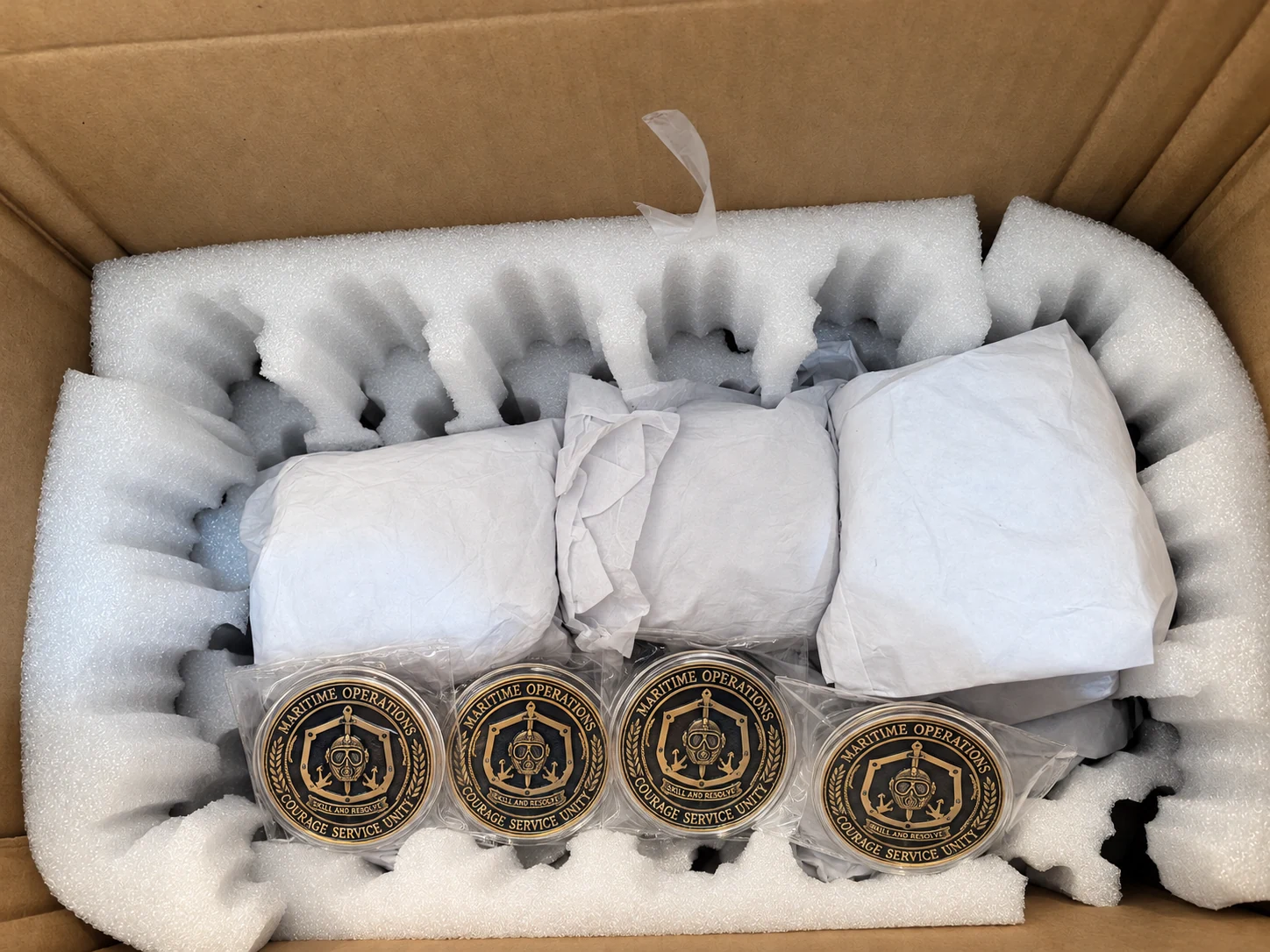 Protective Packaging: retouched coin presentation with substituted lettering and adjusted decorative details